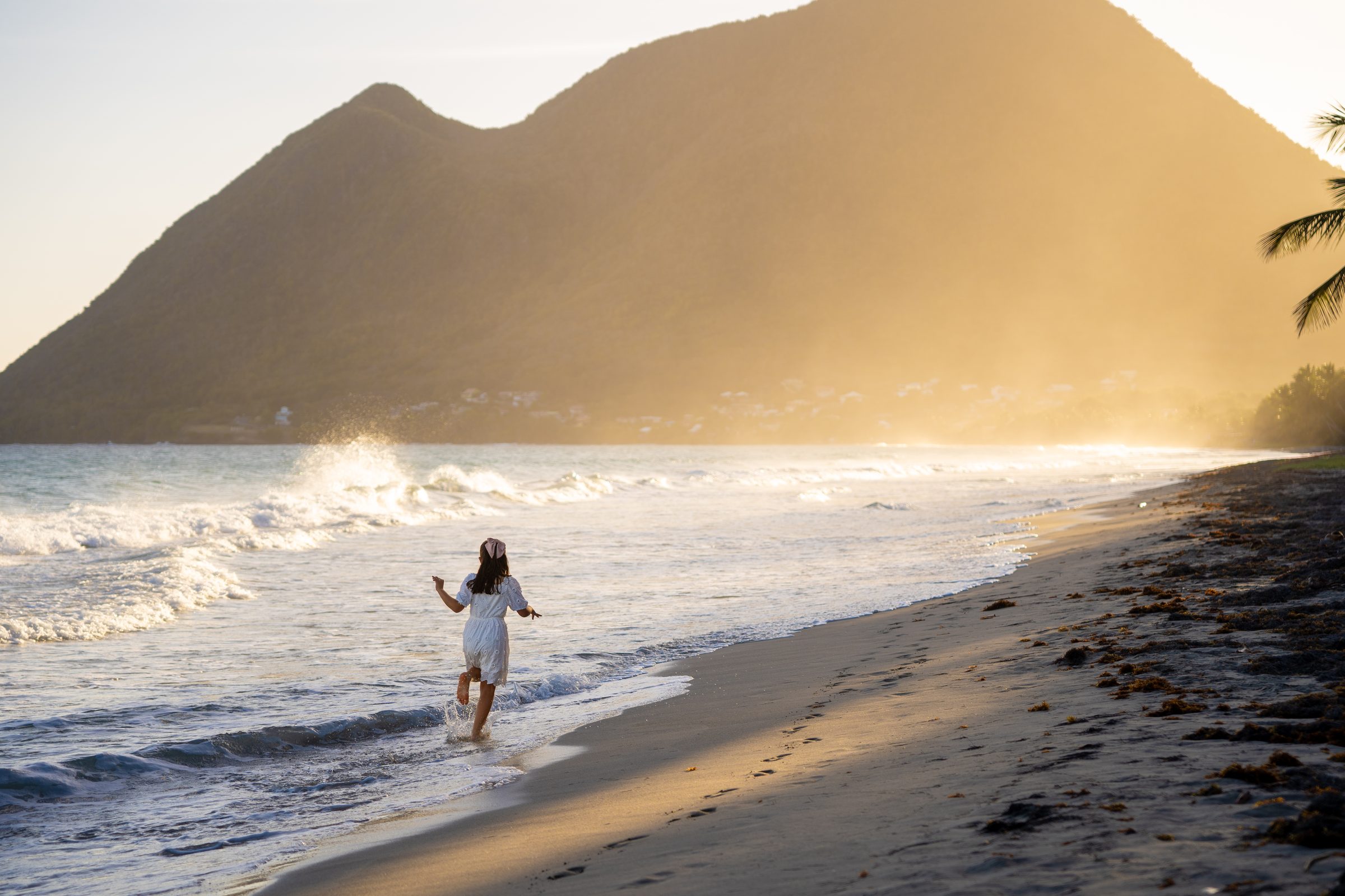 Enfant qui court sur une plage de Martinique au coucher du soleil